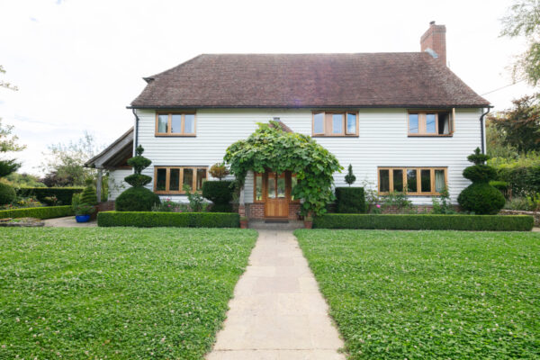 Image of house with clover lawn in front